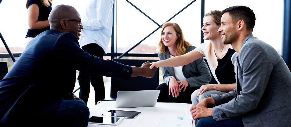 Community banker shaking hands with local business owner business lines of cred