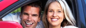 2 people smiling in car