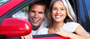 2 people smiling in car