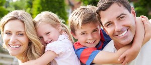 family smiling 4 people