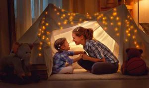 mom and child in blanket tent