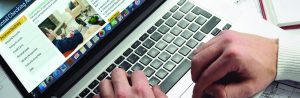 tools to keep you secure header image 1st national bank hands on laptop