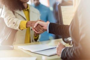 Customer shaking hands with 1st national bank banker