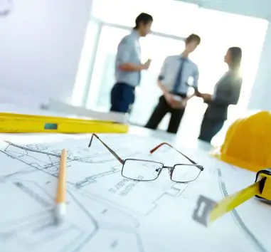 a pair of glasses sitting on top of a blueprint.