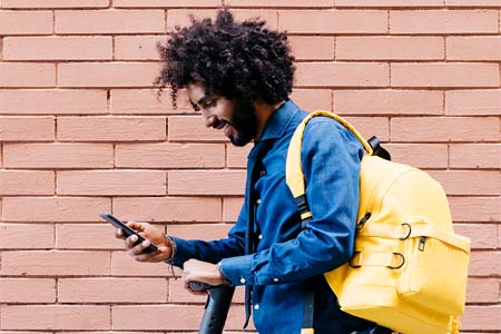 Young man managing his 1st National Bank Credit Card with MyCard Mobile app